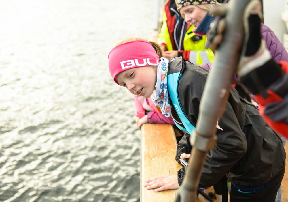 Young girl looking over the boat side